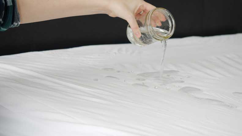 Water spilling on a mattress protector