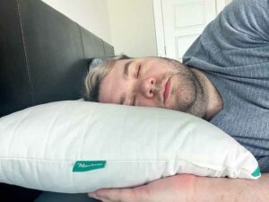 An image of a man sleeping on his side using the Marlow Pillow.