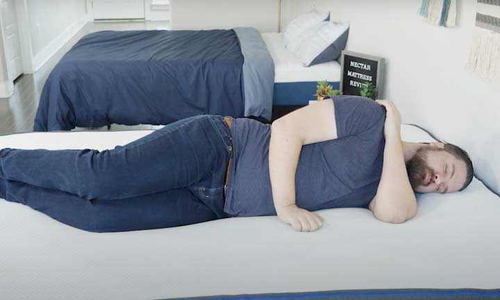 man sleeps on his side on the Nectar mattress